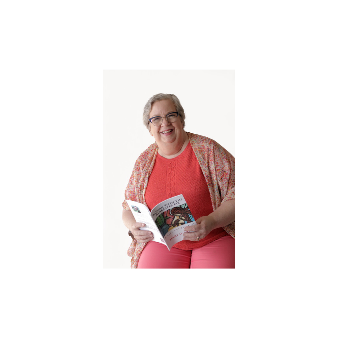 mary-moss-reading-book-author-portrait Mary Moss smiling while holding and reading one of her published books.