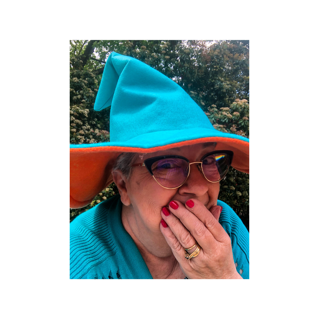 mary-moss-word-wizard-portrait Mary Moss dressed as the Word Wizard, smiling playfully outdoors.